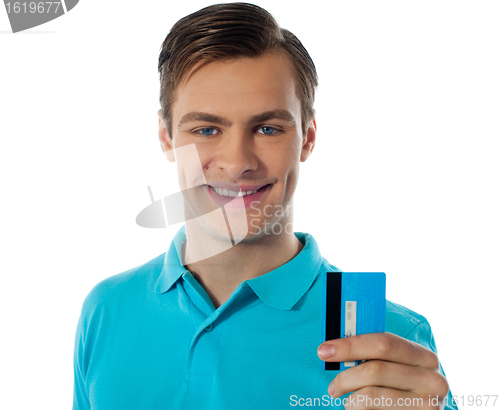 Image of Close-up portrait of fashionable guy holding debit card