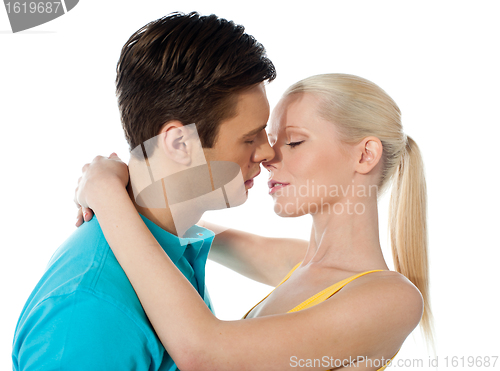 Image of Young couple hugging and kissing