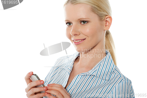 Image of Beautiful corporate female using cellphone