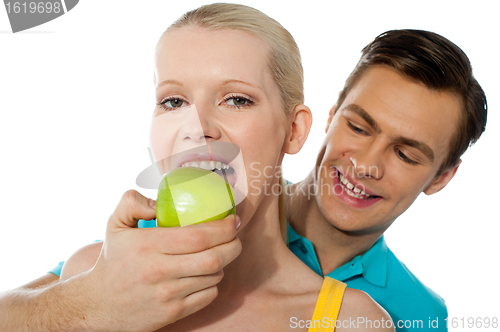 Image of Love couple. Girlfriend eating an apple