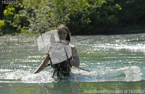 Image of teen and stallion in river