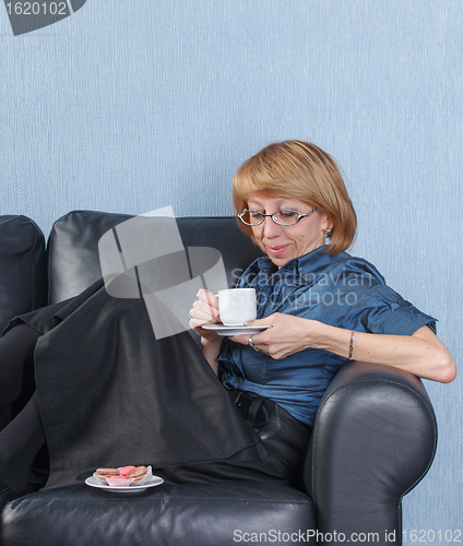 Image of woman drink coffee on couch