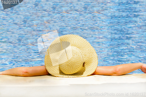 Image of Woman in hat relaxing on holiday