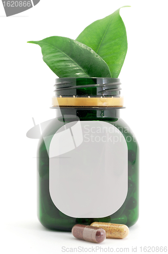 Image of Capsules Pills Bio and Bottle with green leaf