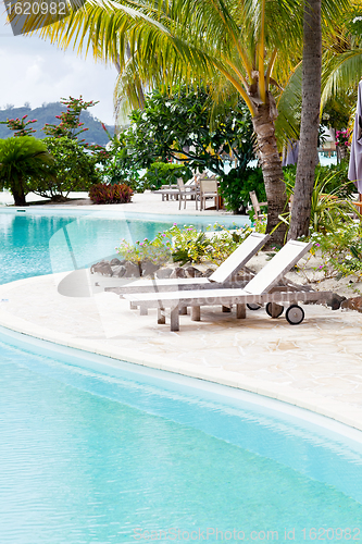 Image of deck chairs by the pool