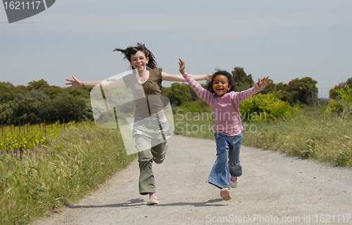 Image of running sisters