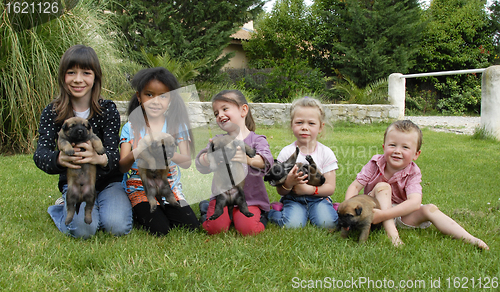 Image of children and puppies