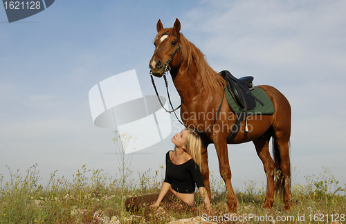 Image of teen and horse in field