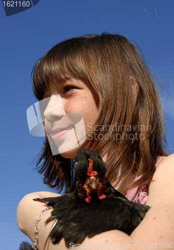 Image of young girl and chicken