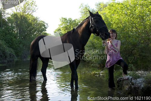 Image of child and horse in river