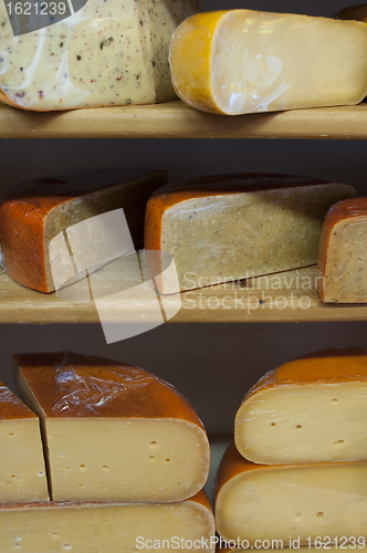 Image of Cut cheese on shelves in store