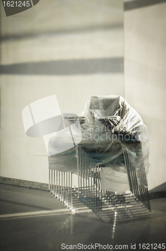 Image of Stack of wrapped office chairs