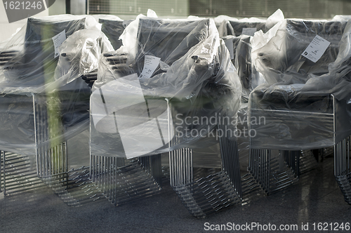 Image of Stacks of wrapped office chairs