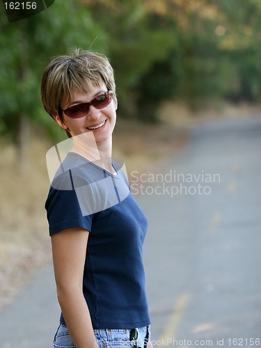 Image of Smiling woman in a park