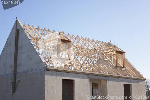 Image of house under construction with the roof structure of wood