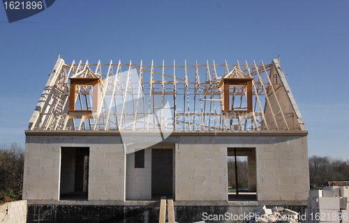 Image of house under construction with the roof structure of wood