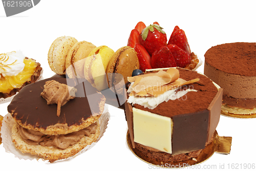 Image of assortment of small cakes on a white background