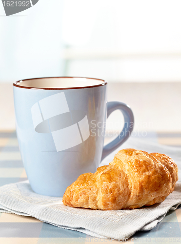 Image of croissant and tea cup