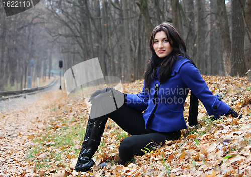 Image of Young woman in the autumn park