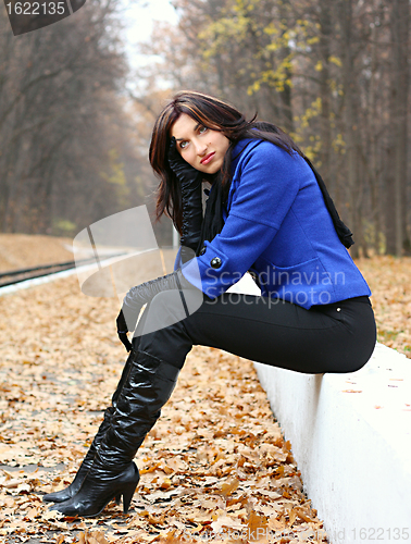 Image of Young woman in the autumn park