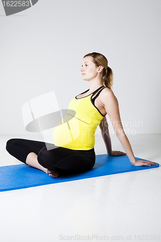 Image of Pregnant woman stretching and relaxing