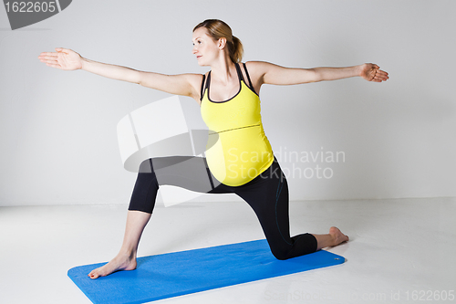 Image of Pregnant woman doing yoga exercise