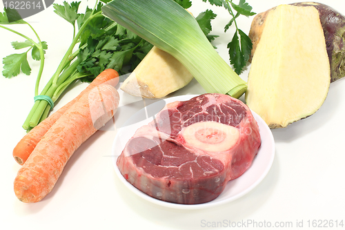 Image of fresh raw leg slice with soup vegetables