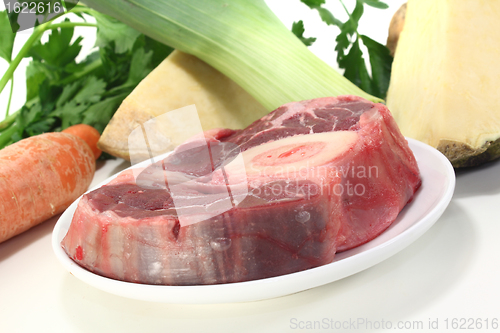 Image of raw leg slice with soup vegetables