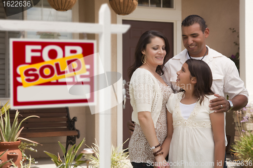 Image of Hispanic Family in Front of Home with Sold Real Estate Sign