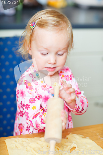 Image of Toddler girl helping at kitchen