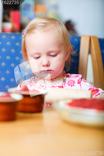 Image of Little girl helping at kitchen