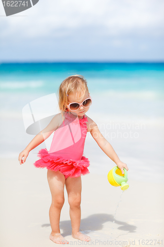 Image of Little girl playing at beach