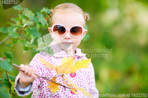 Image of Cute girl in autumn park