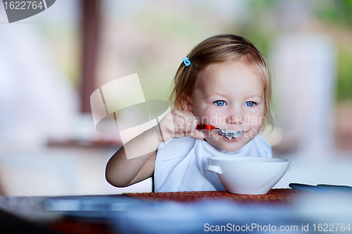 Image of Toddler girl having breakfast