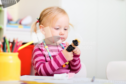 Image of Toddler girl playing with finger puppets