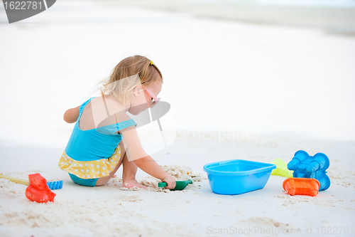 Image of Little girl playing at beach