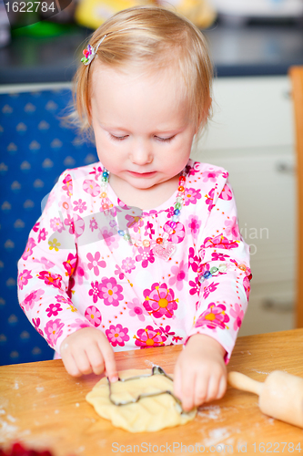 Image of Little girl baking cookies