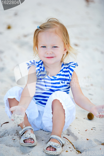 Image of Little girl playing with sand