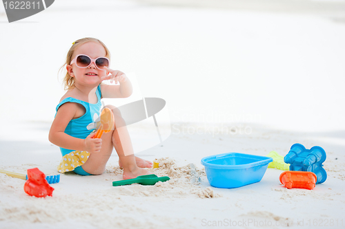 Image of Little girl playing at beach