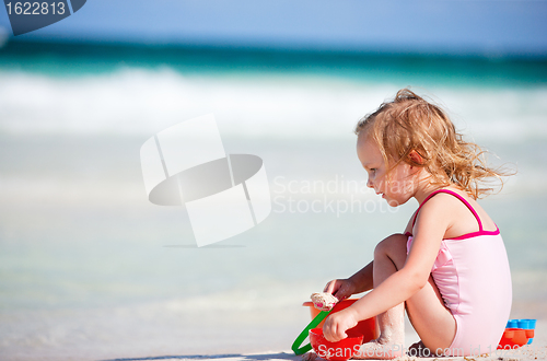 Image of Little girl playing at beach