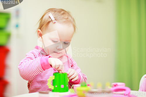 Image of Little girl playing with toys