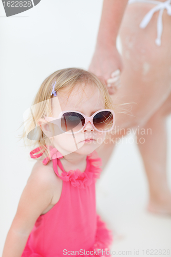 Image of Toddler girl and mother at beach