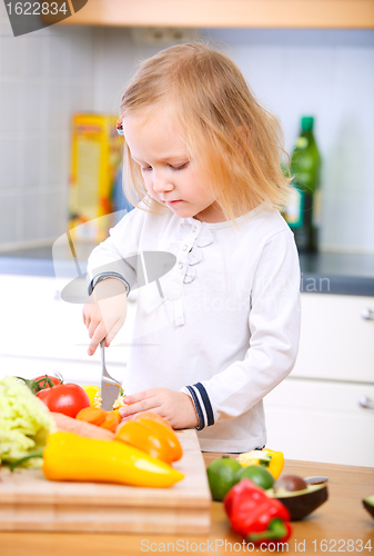 Image of Adorable little girl helping at kitchen