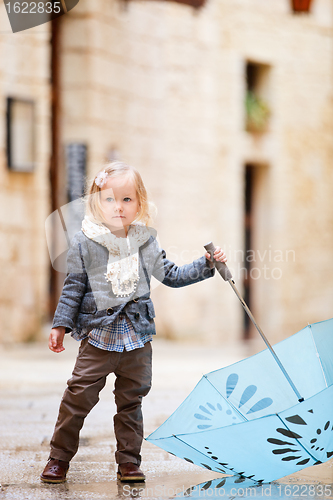 Image of Little girl on rainy day