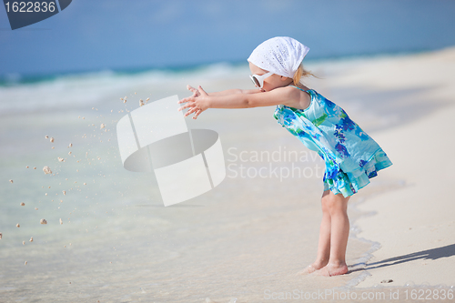 Image of Little playful girl at beach