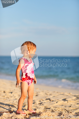 Image of Toddler girl on beach at sunset