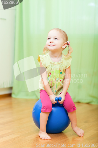 Image of Toddler girl jumping on ball