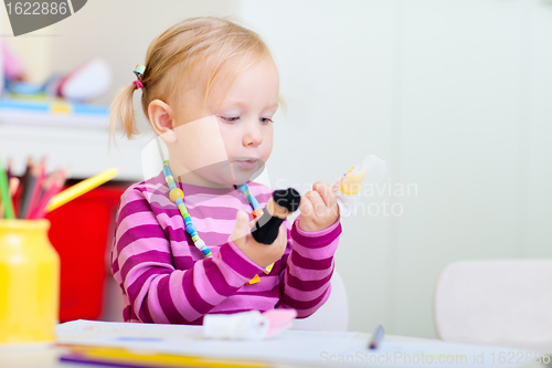 Image of Toddler girl playing with finger toys