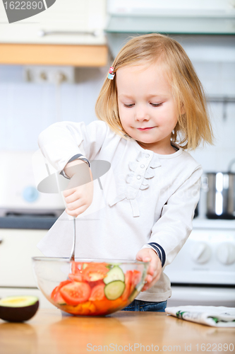 Image of Adorable little girl helping at kitchen