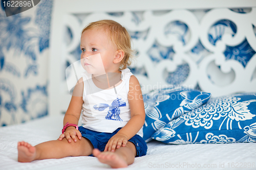 Image of Adorable thoughtful toddler girl in bedroom